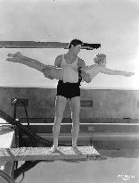 JOHNNY WEISSMULLER ? giving UNA MERKEL a lesson in diving