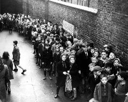CHILDREN QUEUEING FOR A S