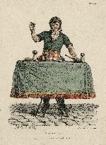 Magician performing trick on table with cup and balls