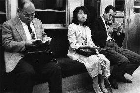 Three passengers on the Tokyo underground