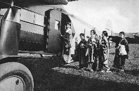 A group of Japanese women board an aircraft