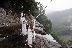 Sacred rope exchange event at western Japan waterfall