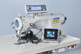 Sewing machine for sewing fasteners without tape jointly developed by JUKI and YKK.