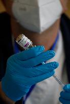 Health workers prepare doses of the AstraZeneca vaccine