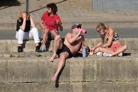 People Enjoying the Warm Weather Paris