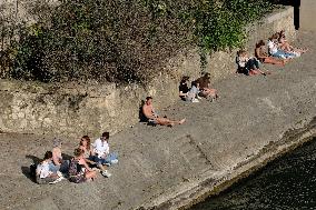 People Enjoying the Warm Weather Paris