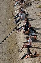 People Enjoying the Warm Weather Paris