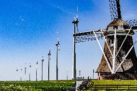 Windmill Alongside Wind Turbines - Netherlands