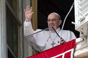 Pope Francis waves from the window of the apostolic palace