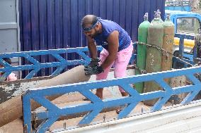 Workers supply oxygen tanks as new Delta variant of Covid-19