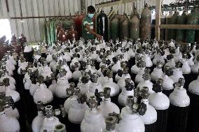 Workers supply oxygen tanks as new Delta variant of Covid-19
