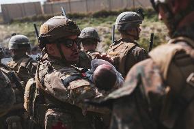 Soldiers with Babies at Hamid Karzai International Airport - Kabul