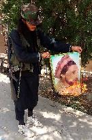 Taliban fighter Setting fire on picture of Massoud - Kabul