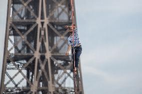 Nathan Paulin Traverses A Slackline Between The Eiffel Tower And The Chaillot Theater
