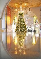 Giant mannequin character decorated with Christmas lights