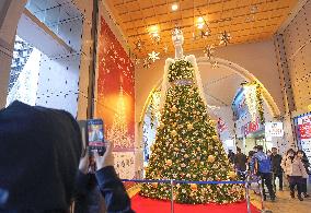 Giant mannequin character decorated with Christmas lights