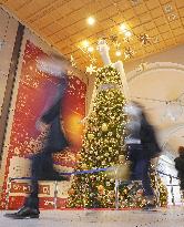 Giant mannequin character decorated with Christmas lights