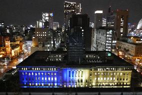 Kanagawa prefectural gov't building lit up in blue and yellow