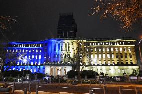 Kanagawa prefectural gov't building lit up in blue and yellow