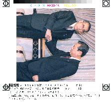 Obuchi, Ozawa shake hands after talks on coalition