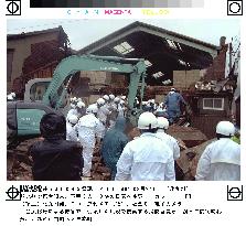 Firefighters examine typhoon-hit house in Kitakyushu