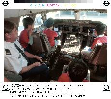 80 kids enjoy tour of jumbo jet at Narita airport