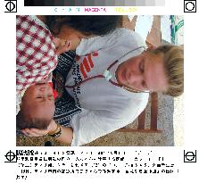 Doctors Without Borders worker examines baby in Dili