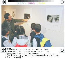 Children visit photo exhibition of nuclear victims