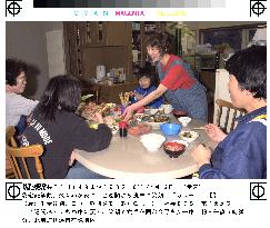 Family enjoy dinner at home near Mt. Usu