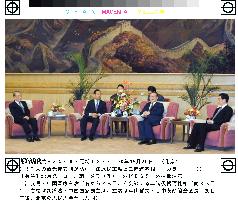 Japanese Transport Minister Nikai speaks with Jiang