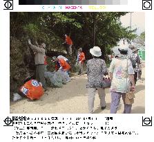 Naha citizens clean street along Shuri Castle Park