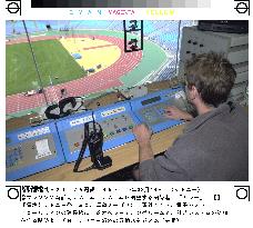 Technician adjusts new timing system for Olympics