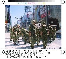 Camouflaged GSDF troops do drills in Ginza