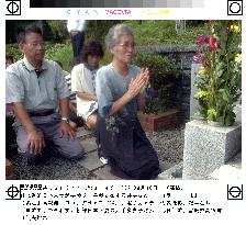 Japanese woman from N. Korea prays at family grave