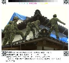SDF personnel cover damaged roof in quake-hit Tottori