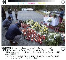 Relatives of 10 Japanese victims mourn before altar in Kaprun