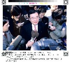 LDP's Kato surrounded by reporters out front of his home