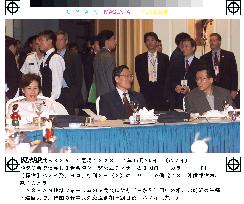 Tanaka sits with colleagues from N. and S. Koreas