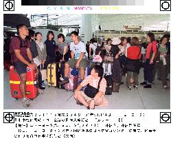 Japanese tourists wait for flights home