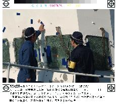 Coast guard staff examine damaged patrol vessel in Kagoshima
