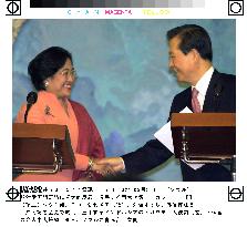 Indonesia's Megawati shakes hands with Kim Dae Jung