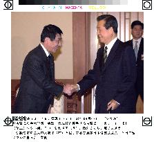 LDP's Koga greeted by Kim