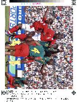 Cameroon, England jump for ball