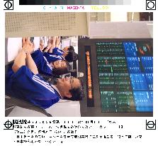 Tokyo Stock Exchange traders wear Japanese soccer uniforms