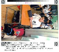 Nagoya teen begins junior high classes with wheelchair dog