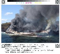 Freighter stranded on Izu-Oshima Island catches fire
