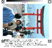 Tourists at Itsukushima Shrine's refurbished Torii gateway