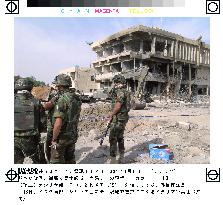 Italian soldiers at bombed military police HQ in Iraq