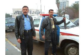 Iraqi policemen patrol Baghdad