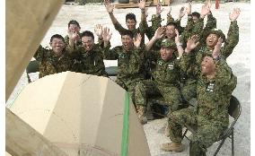 Japanese GSDF troops watch soccer friendly match
